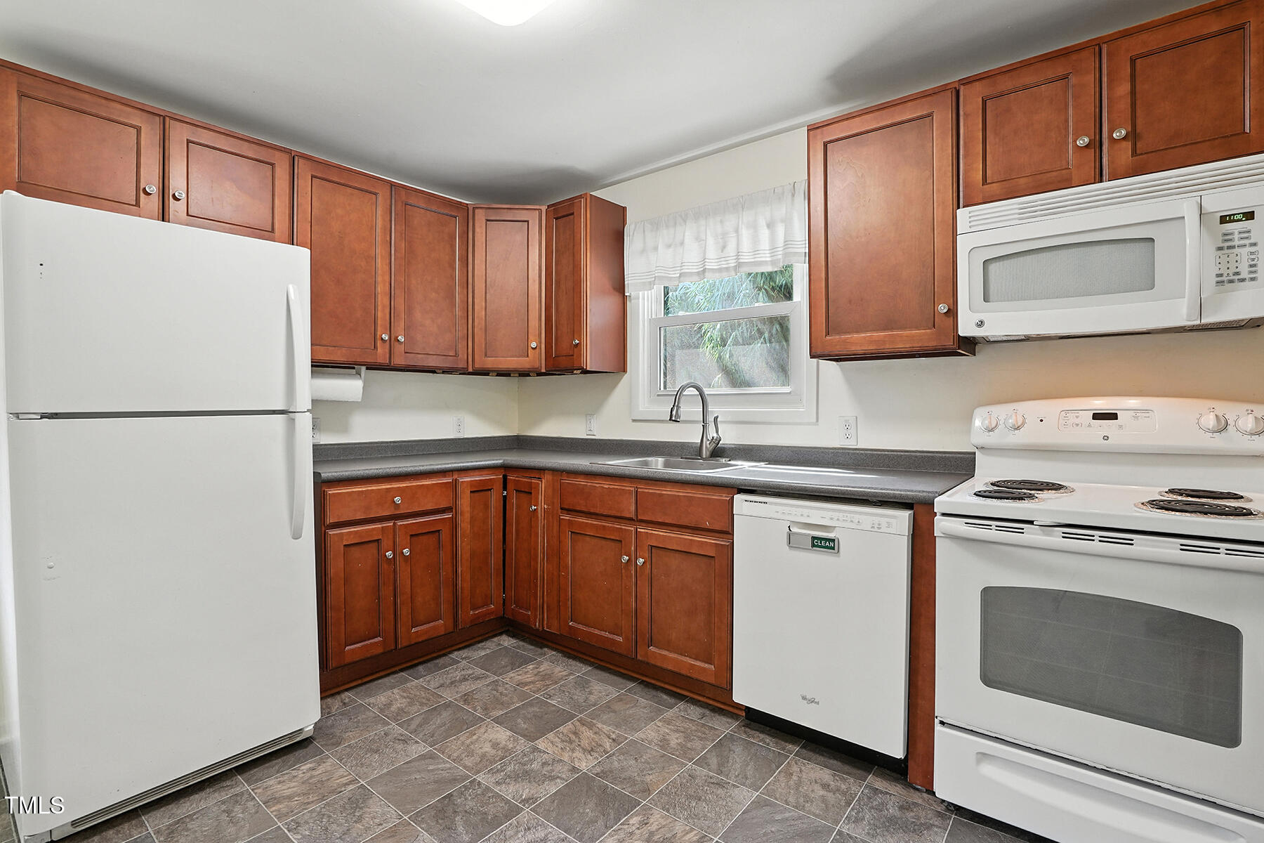 912 Dixie Trail Raleigh, NC 27607 - Photo 11 of 28 a kitchen with stainless steel appliances granite countertop a refrigerator stove a sink and dishwasher