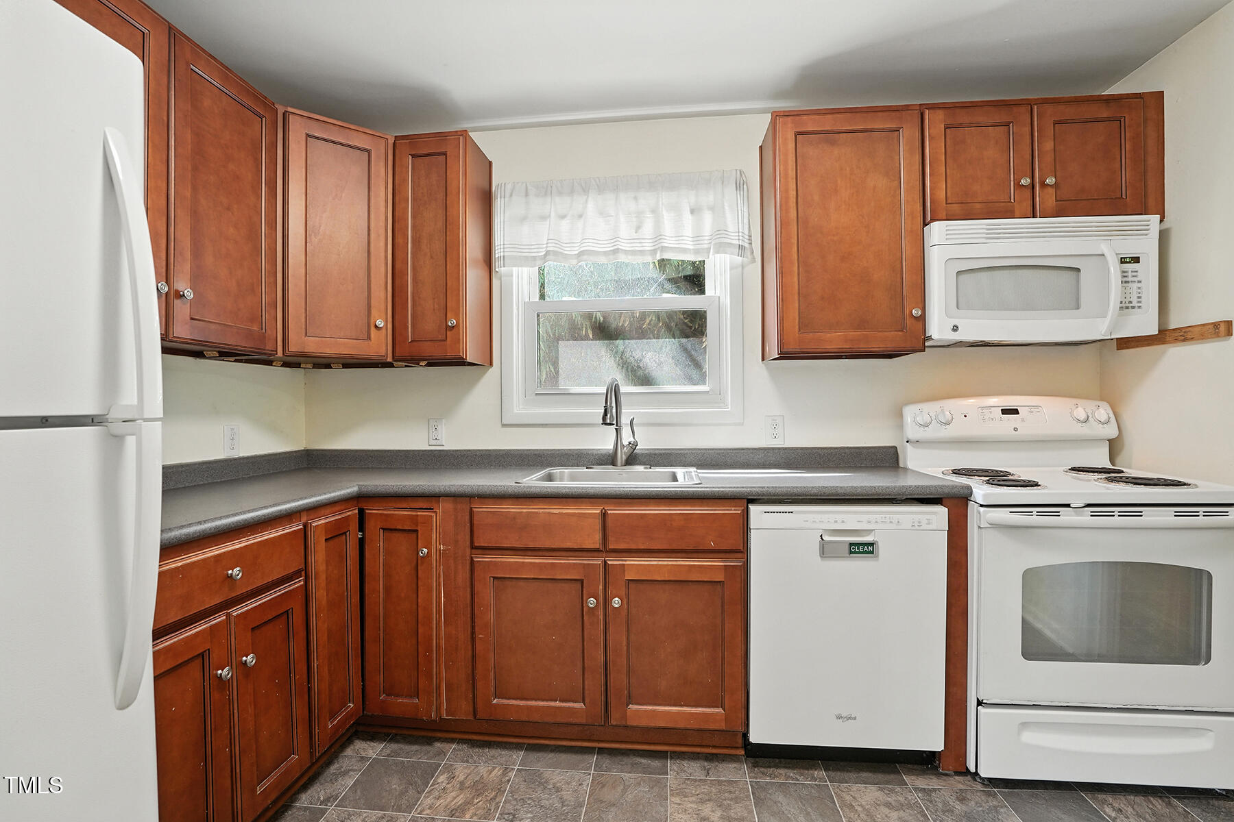 912 Dixie Trail Raleigh, NC 27607 - Photo 12 of 27 a kitchen with granite countertop cabinets stainless steel appliances and sink