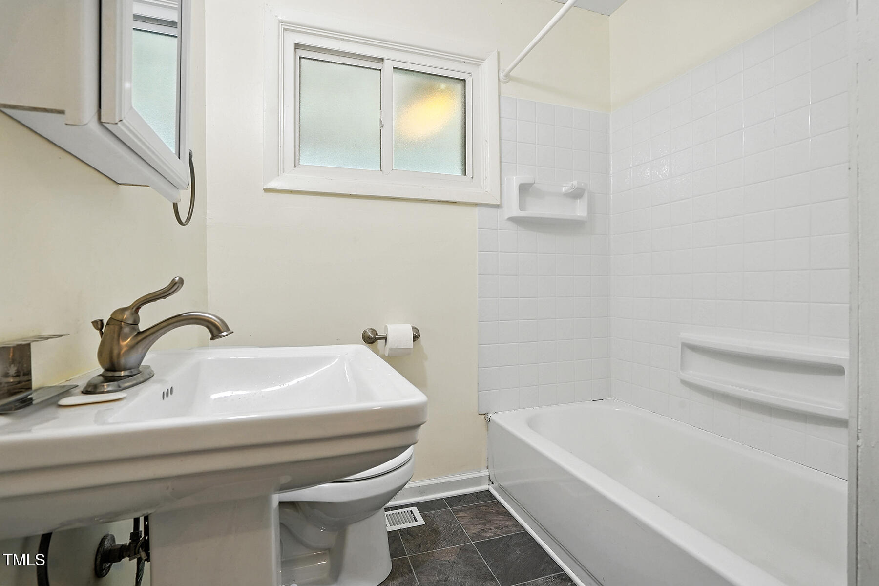 912 Dixie Trail Raleigh, NC 27607 - Photo 16 of 27 a bathroom with a sink and a bathtub