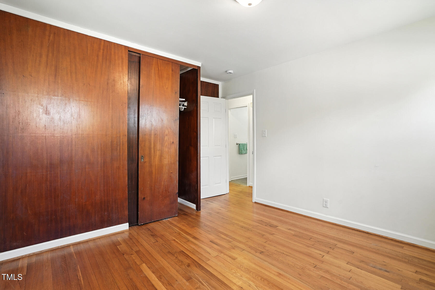 912 Dixie Trail Raleigh, NC 27607 - Photo 18 of 27 a view of an empty room with wooden floor