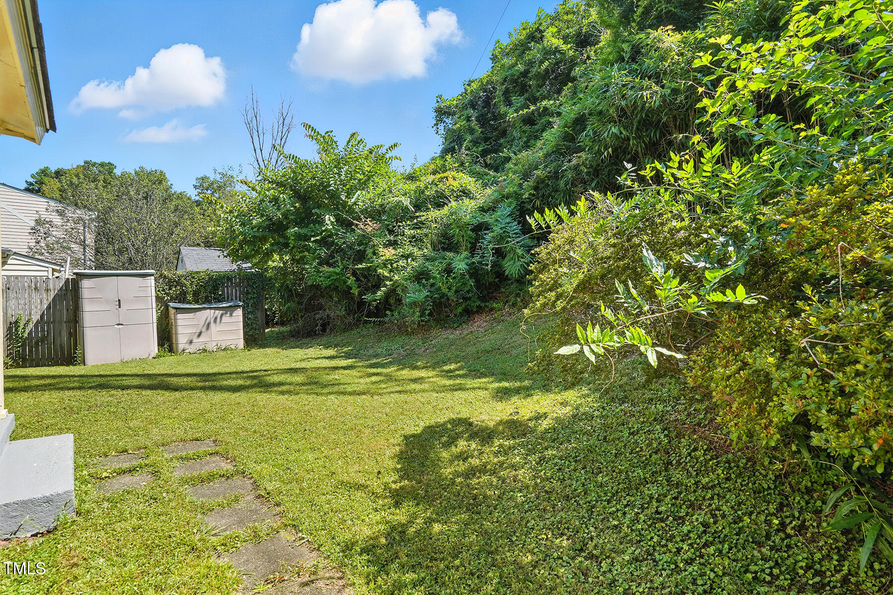 912 Dixie Trail Raleigh, NC 27607 - Photo 23 of 27 a backyard of a house with lots of green space and fountain