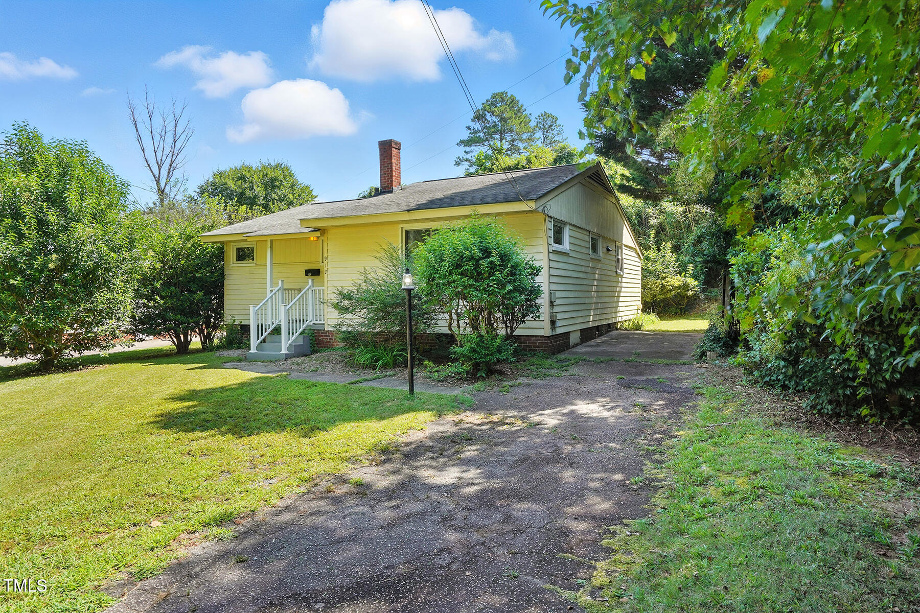 912 Dixie Trail Raleigh, NC 27607 - Photo 3 of 28 a view of a backyard with plants and large trees