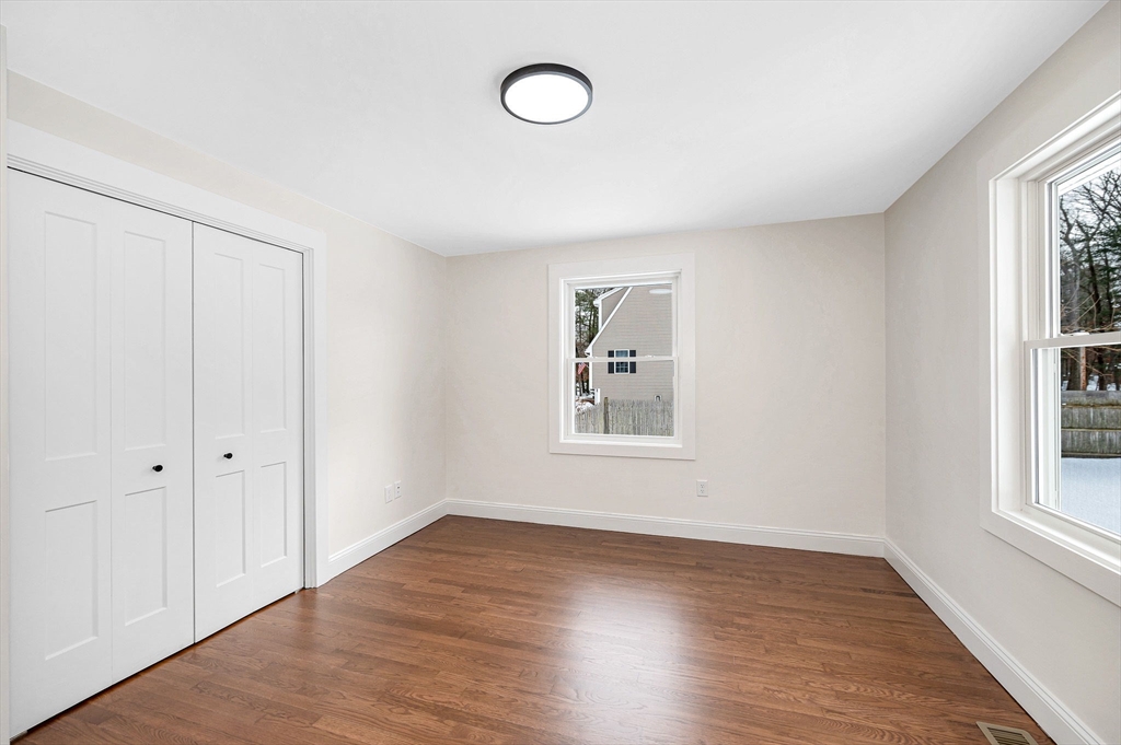 19 Porter Street Billerica, MA 01821 - Photo 14 of 42 an empty room with wooden floor and windows