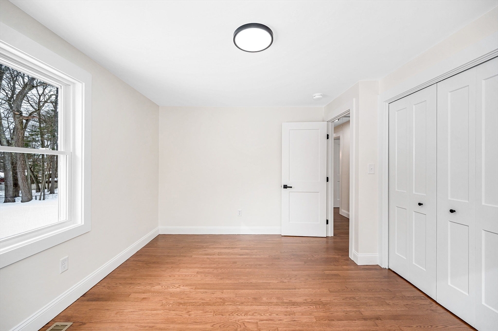 19 Porter Street Billerica, MA 01821 - Photo 15 of 42 a view of a room with wooden floor and windows
