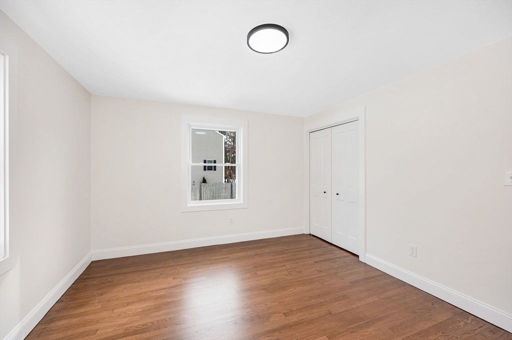 19 Porter Street Billerica, MA 01821 - Photo 19 of 42 an empty room with wooden floor and window