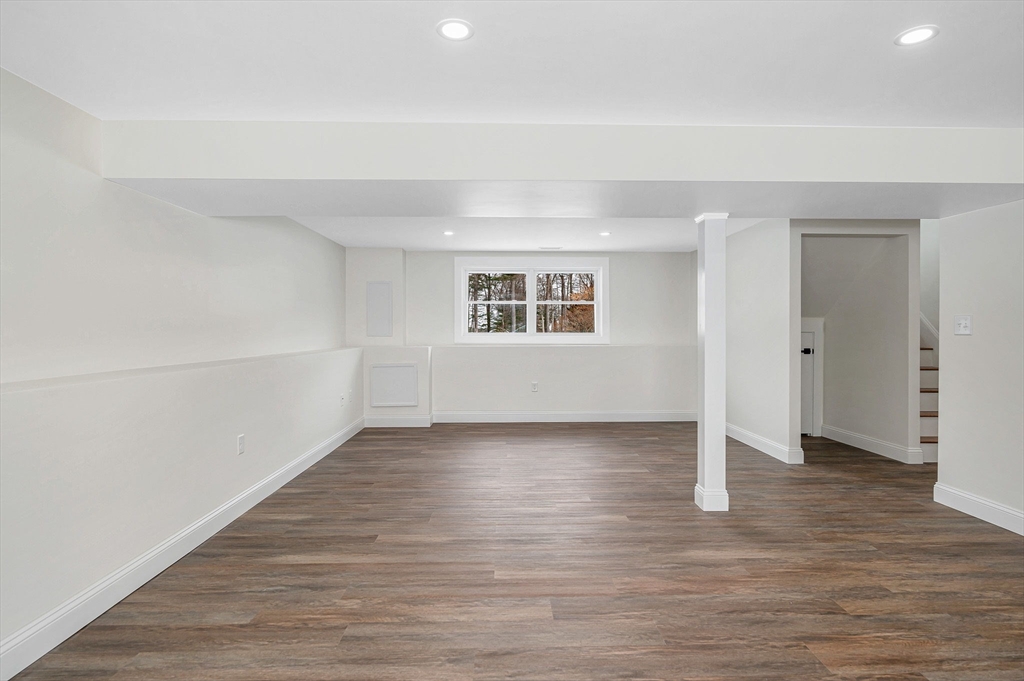 19 Porter Street Billerica, MA 01821 - Photo 22 of 42 a view of an empty room with wooden floor and a window