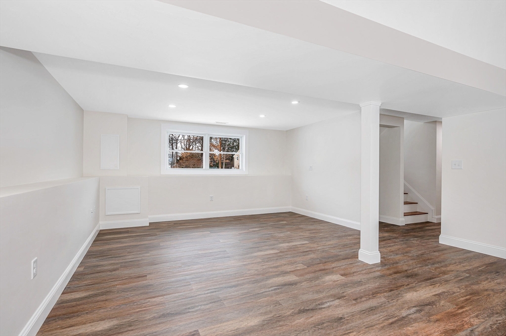 19 Porter Street Billerica, MA 01821 - Photo 24 of 42 an empty room with wooden floor and windows
