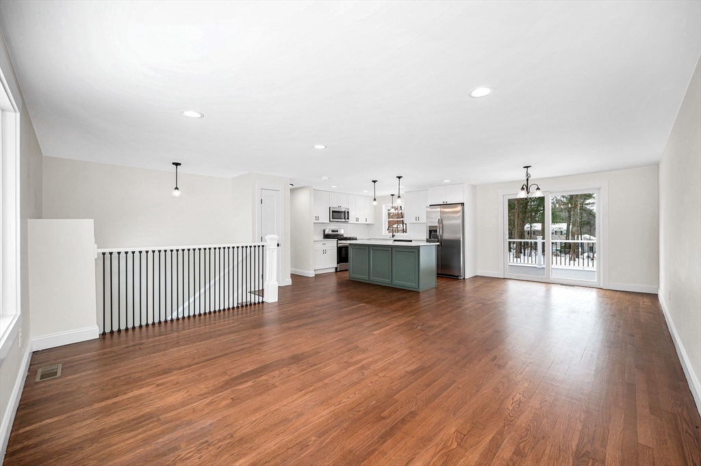 19 Porter Street Billerica, MA 01821 - Photo 3 of 42 an empty room with wooden floor and windows