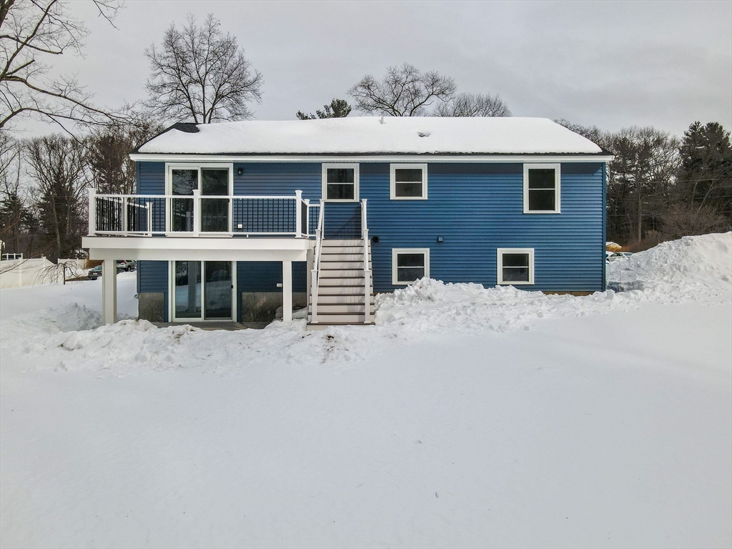19 Porter Street Billerica, MA 01821 - Photo 39 of 42 a front view of a house with a yard covered in snow