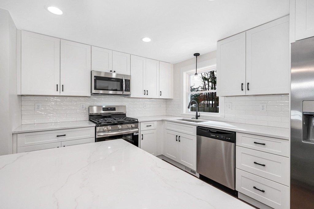 19 Porter Street Billerica, MA 01821 - Photo 9 of 42 a kitchen with cabinets stainless steel appliances and a counter space