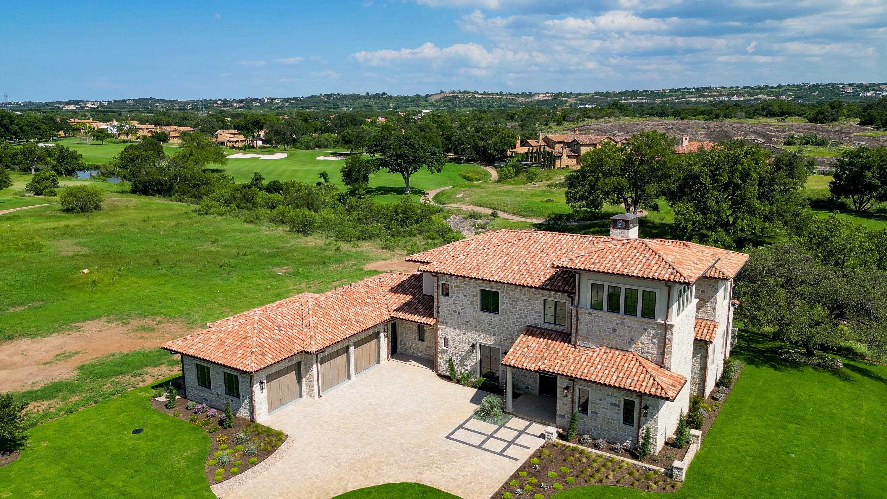 an aerial view of a house with big yard