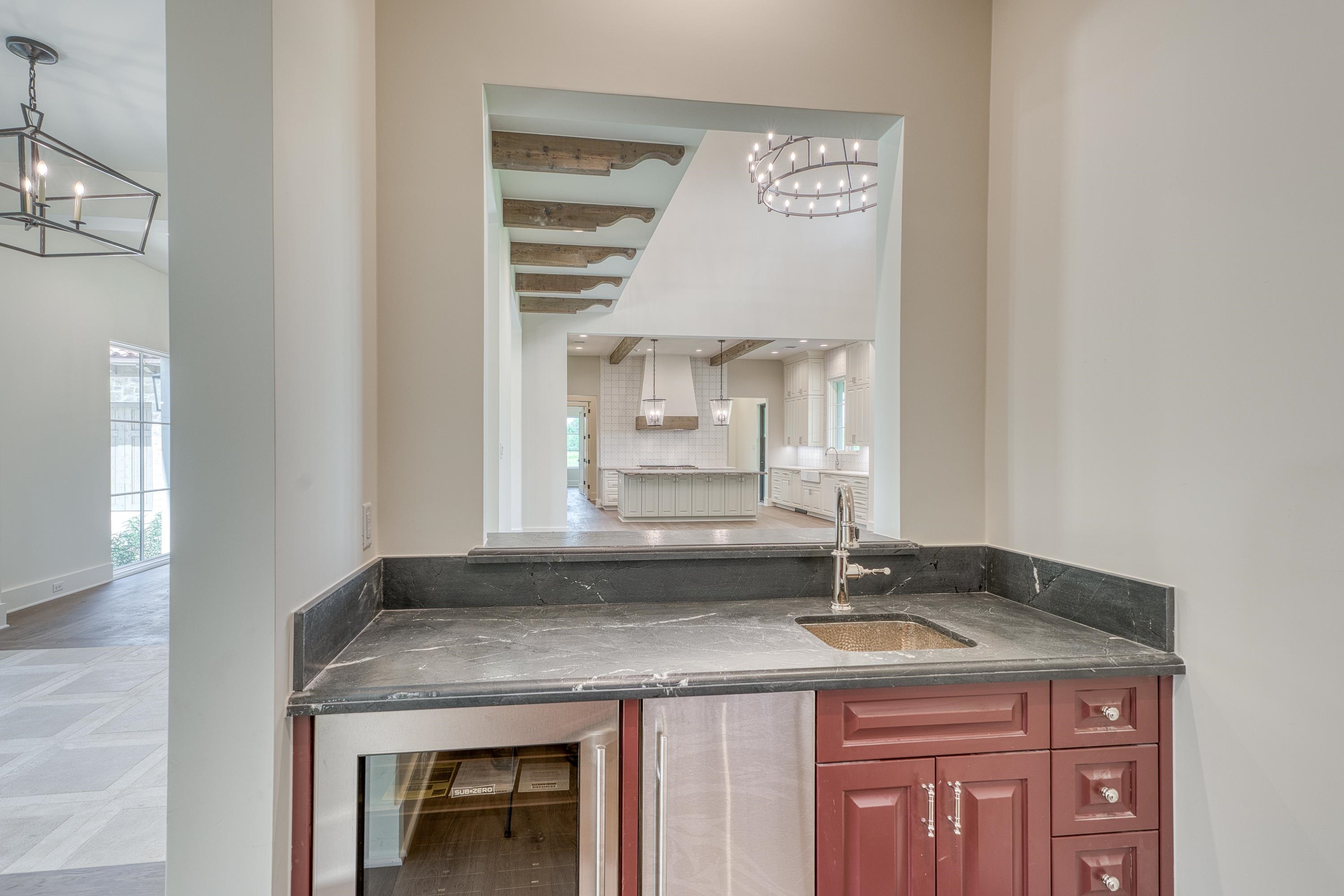 369 La Serena Loop Horseshoe Bay, TX 78657 - Photo 12 of 30 a kitchen with granite countertop a sink a stove and cabinets