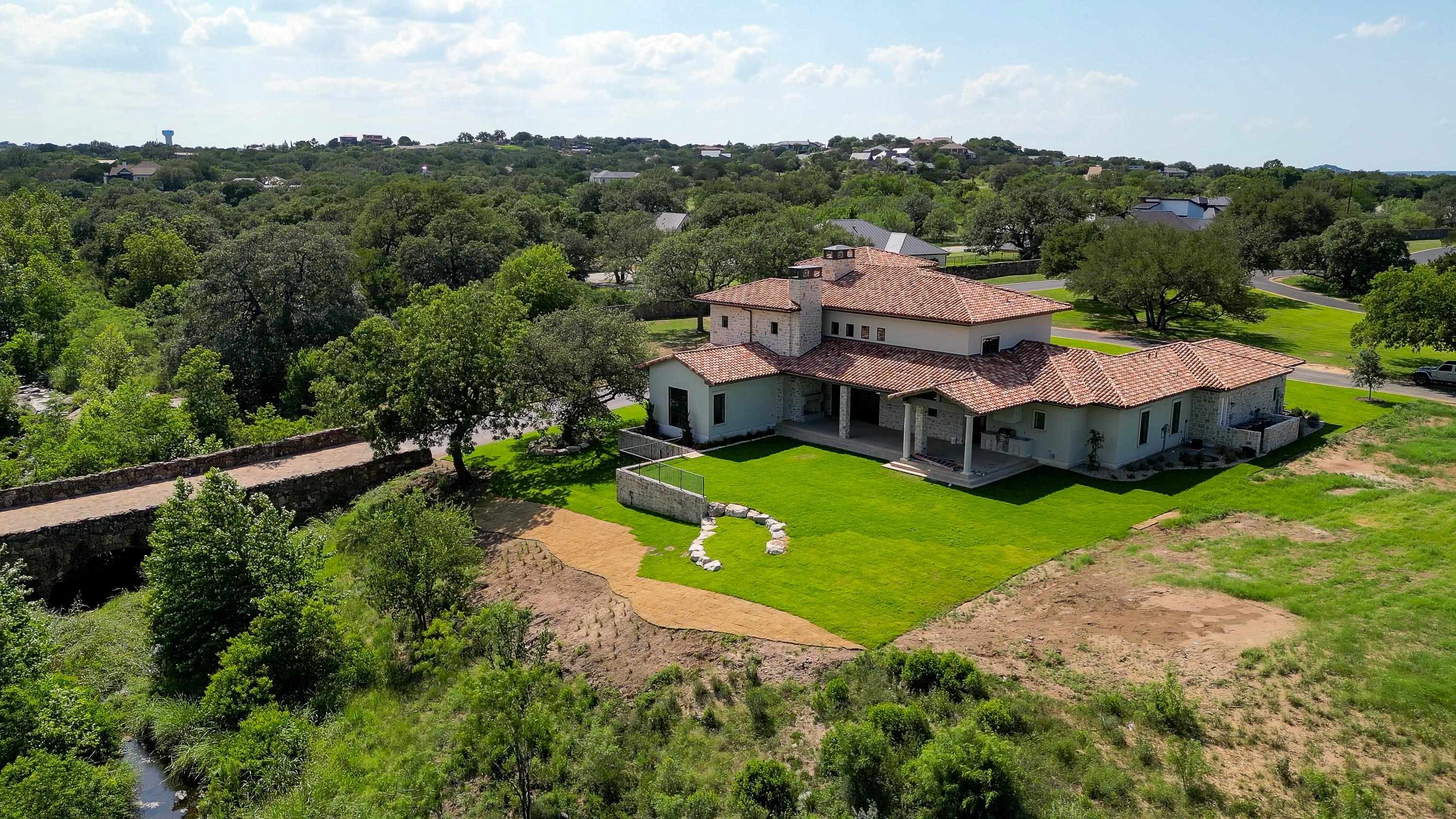 369 La Serena Loop Horseshoe Bay, TX 78657 - Photo 26 of 30 an aerial view of a house with yard and green space