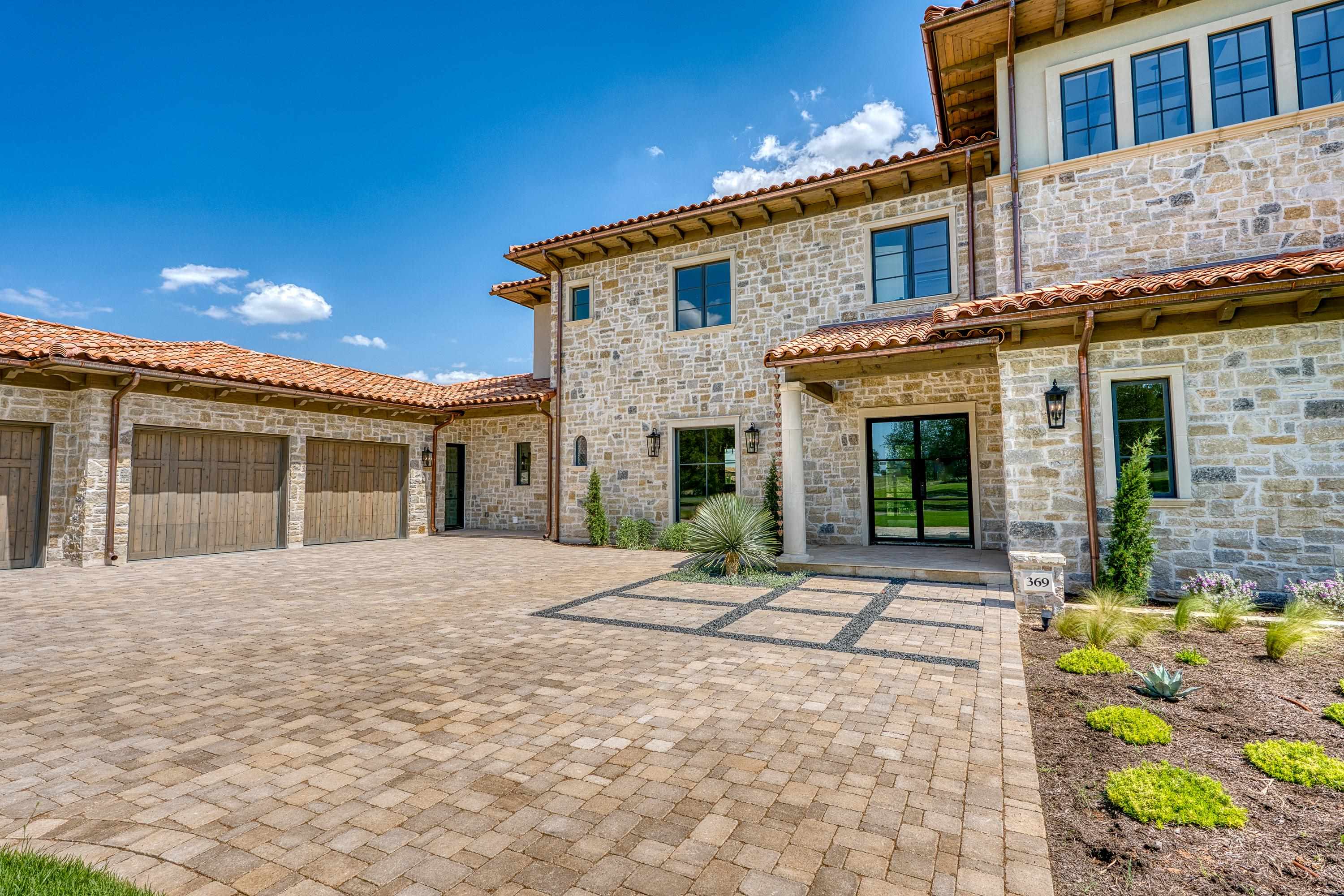 369 La Serena Loop Horseshoe Bay, TX 78657 - Photo 3 of 30 a front view of a house with a garden