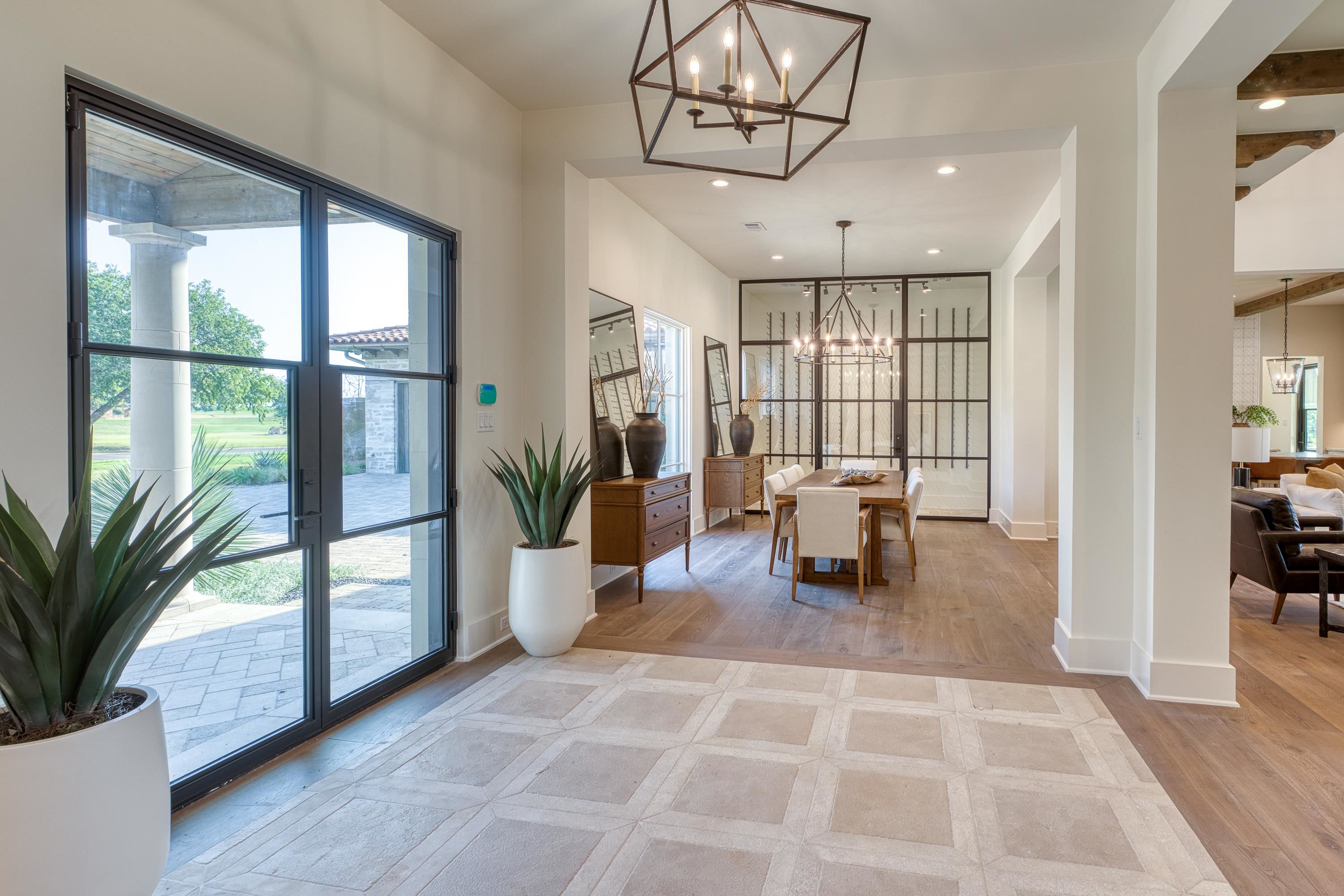 369 La Serena Loop Horseshoe Bay, TX 78657 - Photo 4 of 30 a dining room with wooden floor and a potted plant