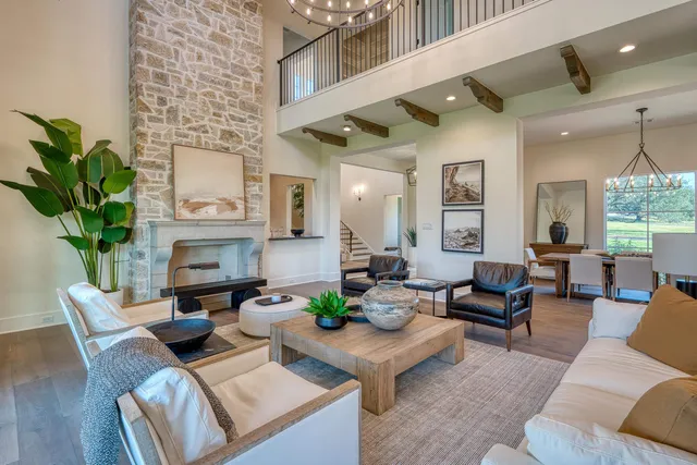 a living room with fireplace furniture and a potted plant