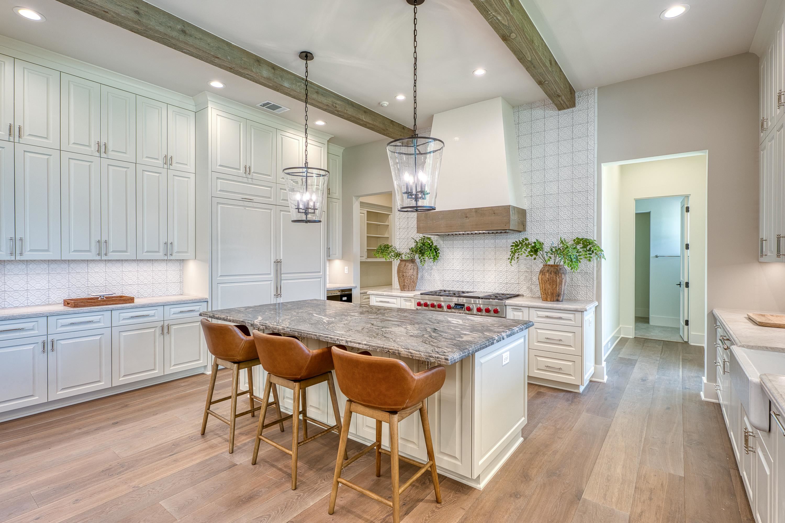 369 La Serena Loop Horseshoe Bay, TX 78657 - Photo 8 of 30 a kitchen with stainless steel appliances granite countertop a stove a sink dishwasher and a refrigerator with wooden floor