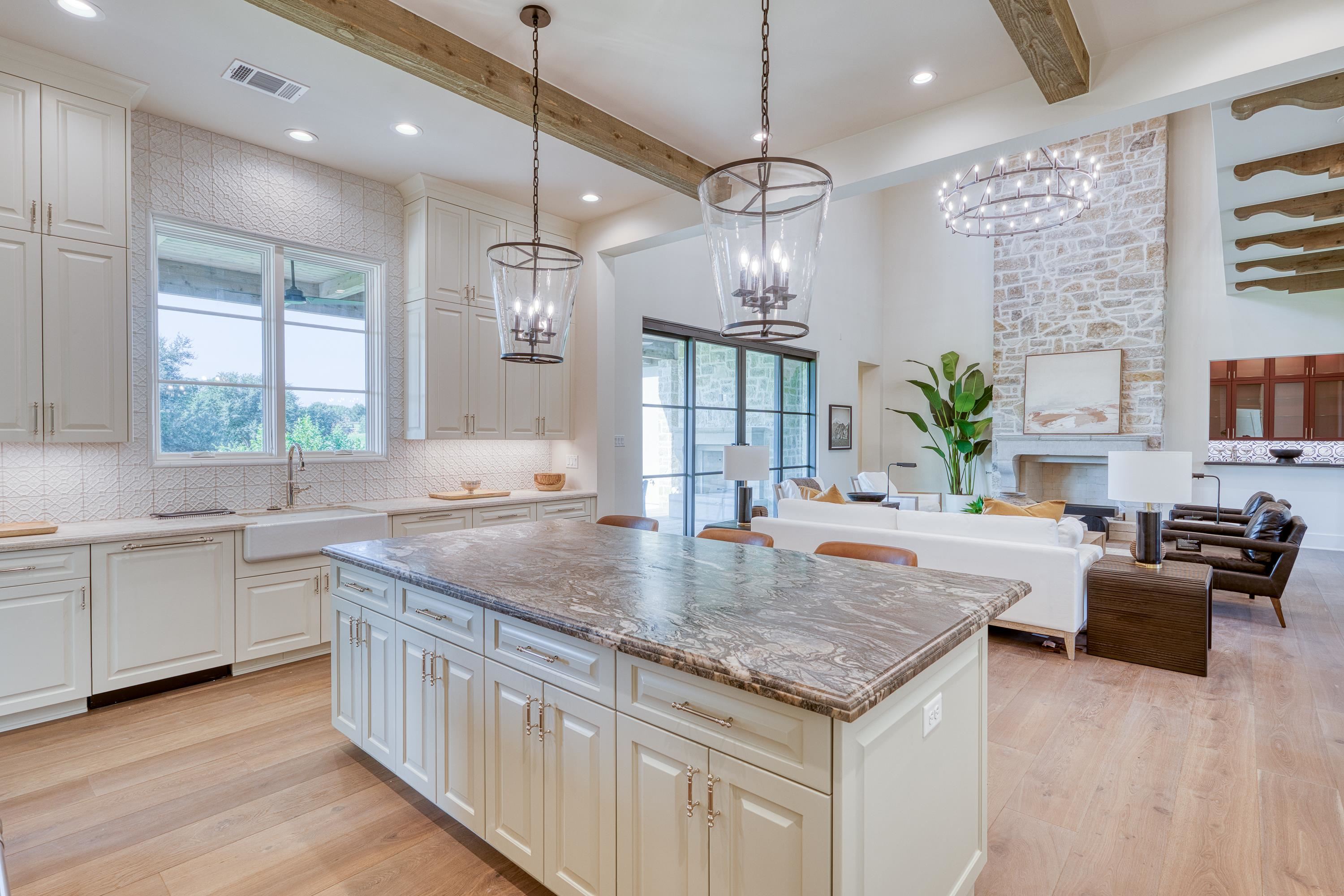 369 La Serena Loop Horseshoe Bay, TX 78657 - Photo 9 of 30 a kitchen with center island a sink dishwasher a stove and a dining table with wooden floor