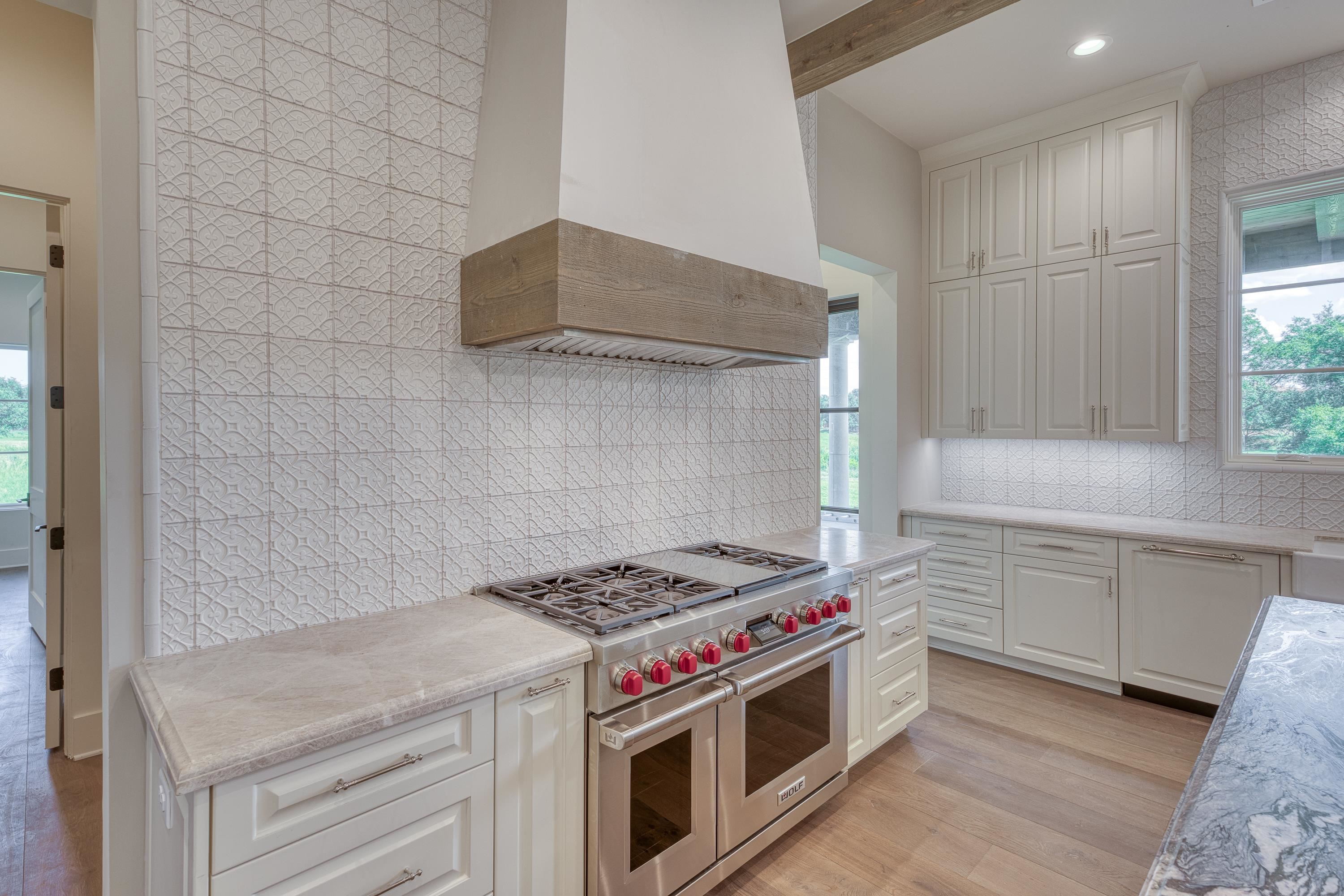 369 La Serena Loop Horseshoe Bay, TX 78657 - Photo 10 of 30 a kitchen with stainless steel appliances granite countertop a stove and a sink