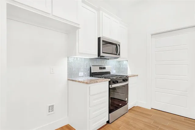 a kitchen with a stove and a microwave