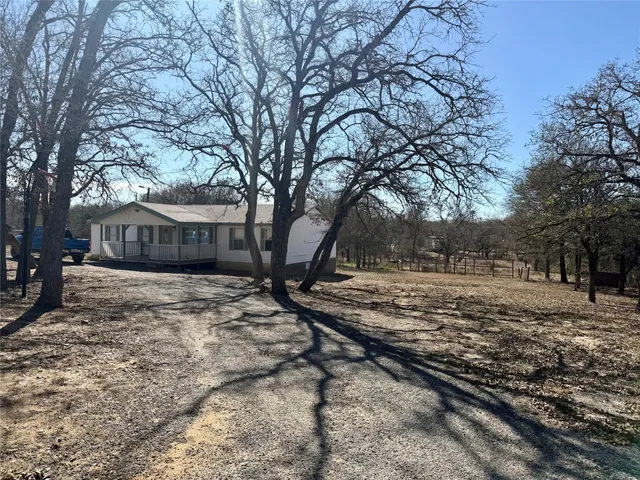 a view of a house with a yard covered with snow