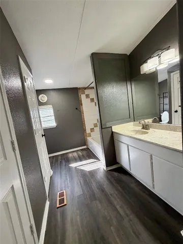 a bathroom with double vanity and a glass door shower