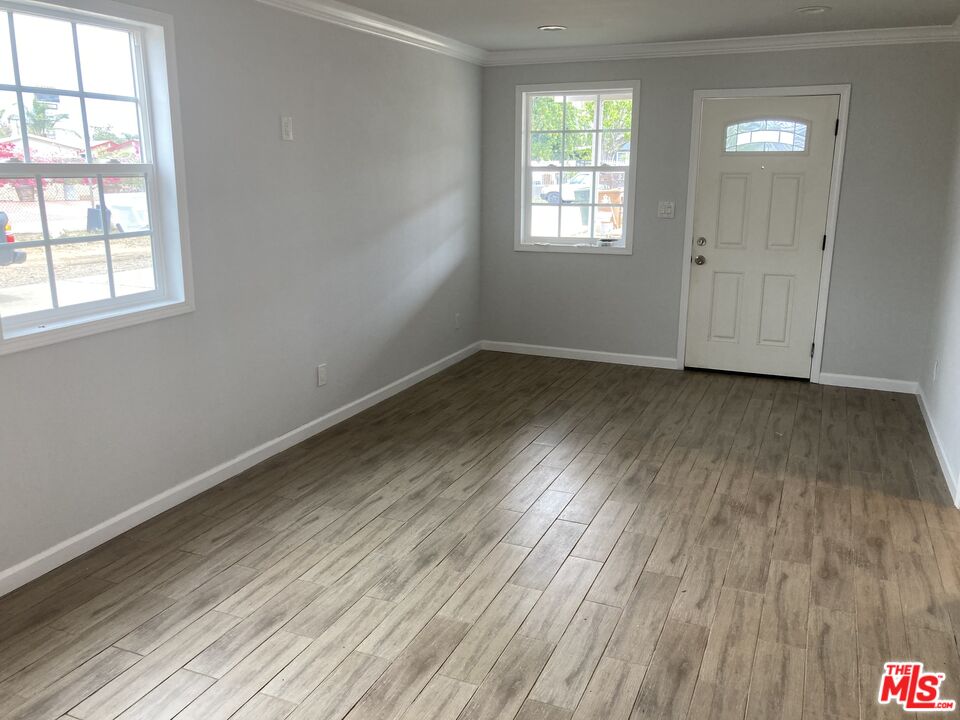 903 Arnold Drive Placentia, CA 92870 - Photo 3 of 11 an empty room with wooden floor and windows