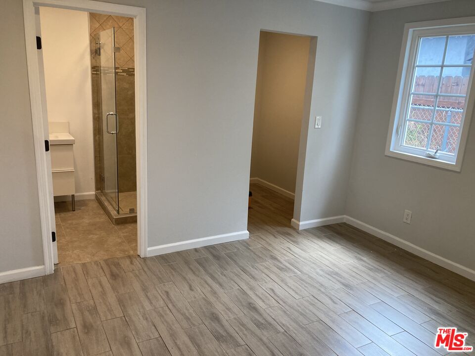 903 Arnold Drive Placentia, CA 92870 - Photo 4 of 11 an empty room with wooden floor and windows