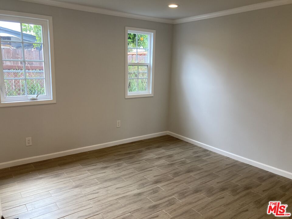 903 Arnold Drive Placentia, CA 92870 - Photo 5 of 11 an empty room with wooden floor and windows