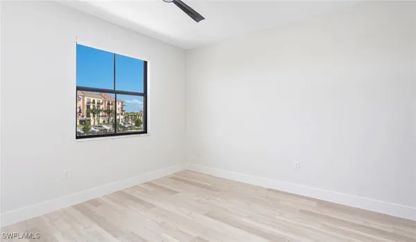a view of a room with wooden floor and window