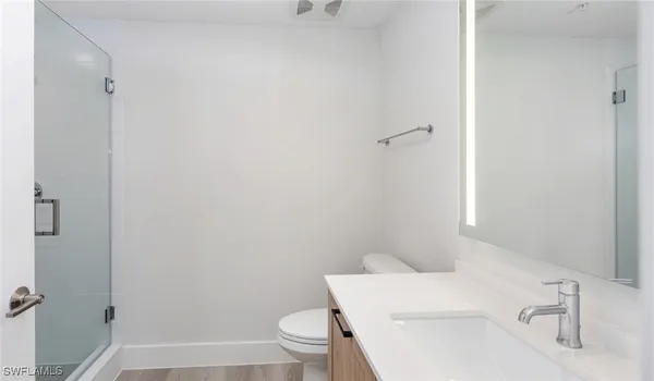 a white toilet sitting next to a bathroom sink
