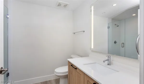 a bathroom with a sink toilet and vanity