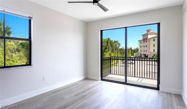 a view of a room with wooden floor and a window