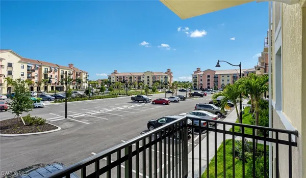 a view of a balcony and car parked
