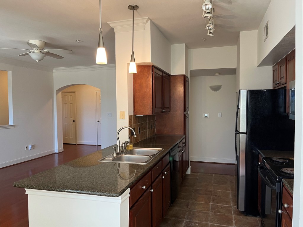 7701 Rialto Boulevard, Unit 1326 Austin, TX 78735 - Photo 1 of 1 a kitchen with kitchen island granite countertop a sink appliances and cabinets