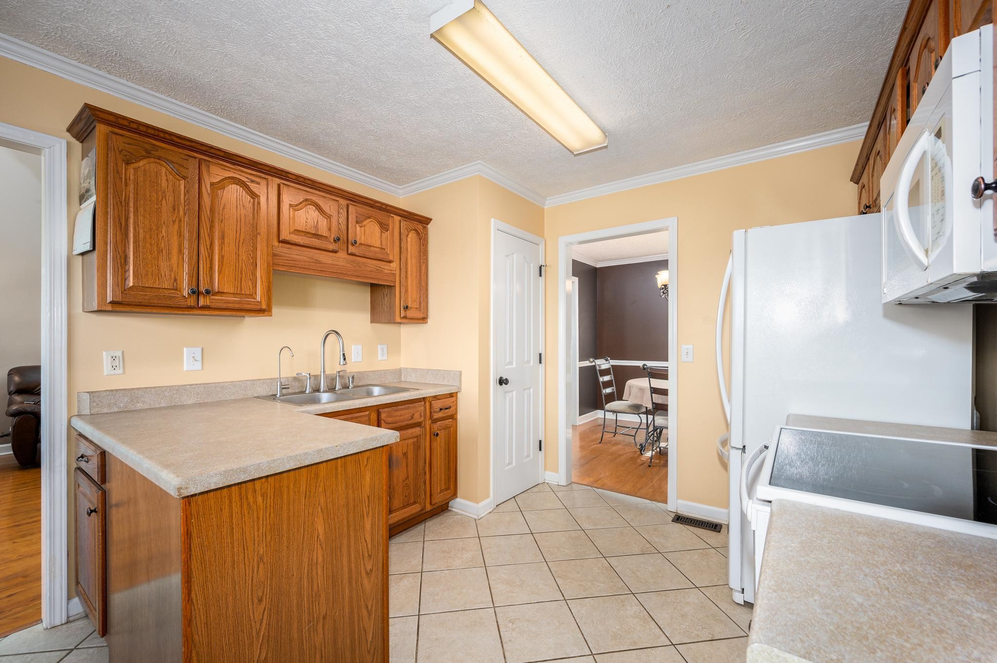 13459 Versailles Road Rockvale, TN 37153 - Photo 11 of 40 a kitchen with a sink a stove and refrigerator