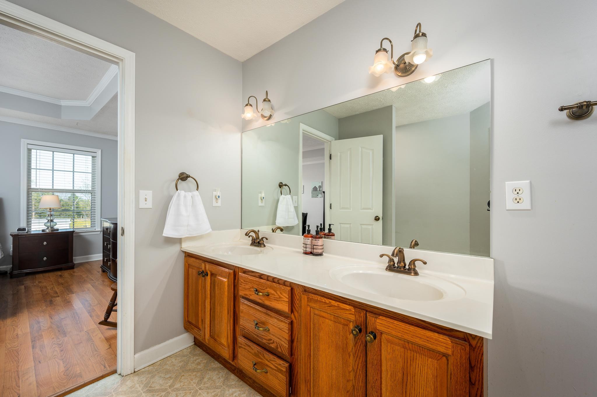 13459 Versailles Road Rockvale, TN 37153 - Photo 15 of 40 a bathroom with a sink double vanity mirror and tub