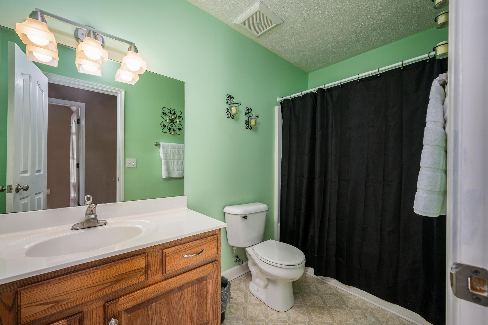 13459 Versailles Road Rockvale, TN 37153 - Photo 17 of 40 a bathroom with a granite countertop sink toilet and shower