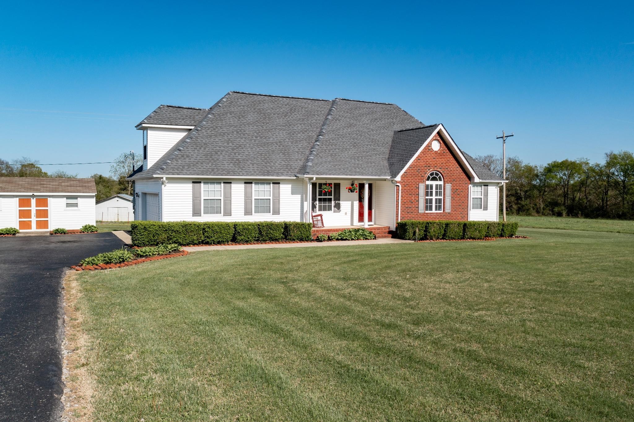 13459 Versailles Road Rockvale, TN 37153 - Photo 3 of 40 a front view of a house with a garden