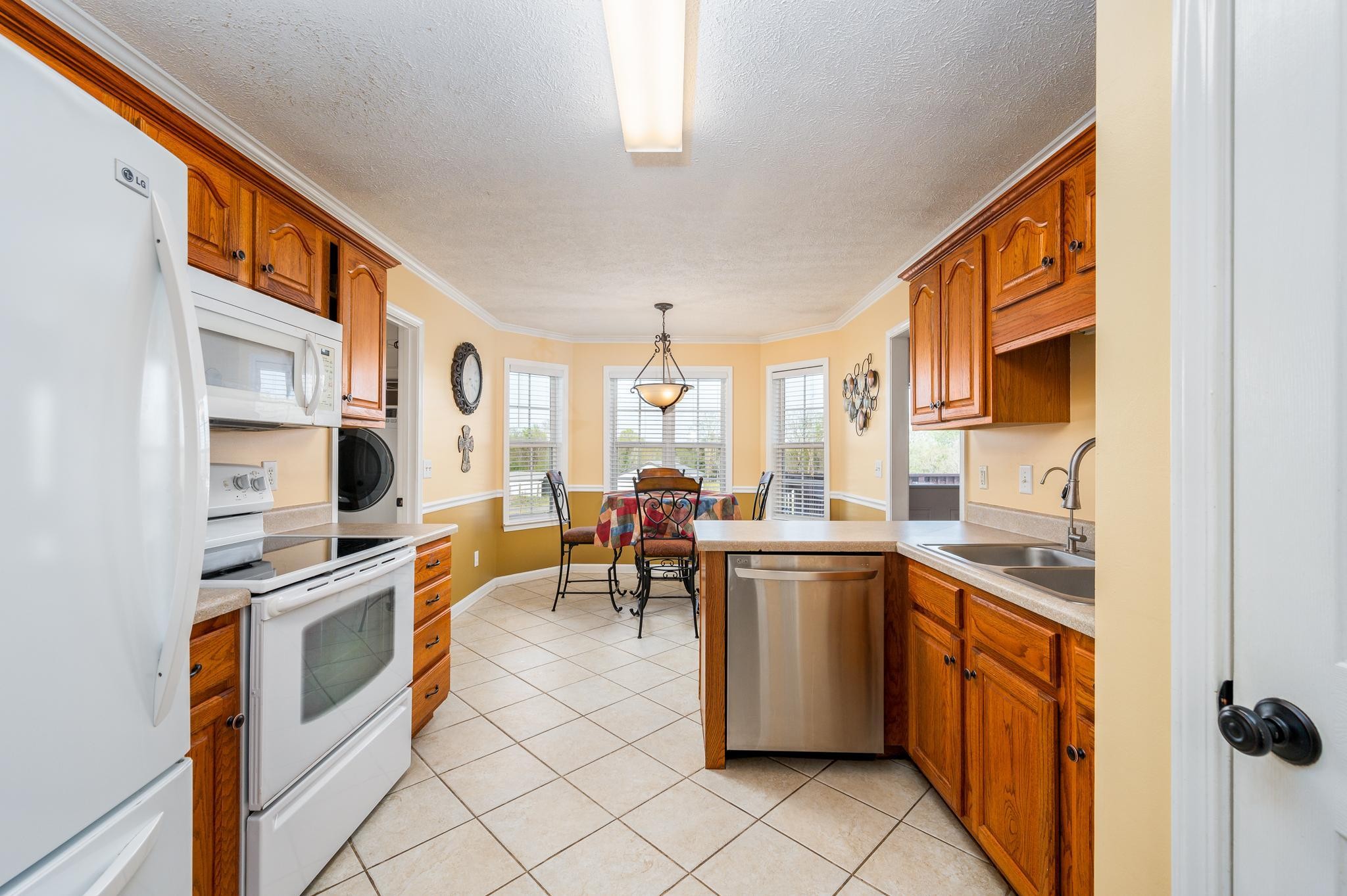 13459 Versailles Road Rockvale, TN 37153 - Photo 10 of 40 a kitchen with stainless steel appliances granite countertop sink stove top oven and microwave