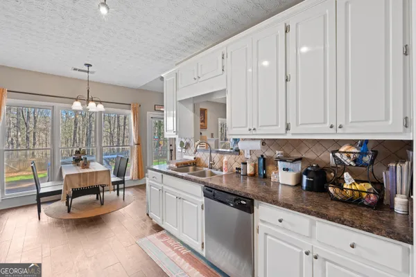 a kitchen with sink cabinets and living room view