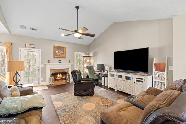 a living room with furniture and a flat screen tv
