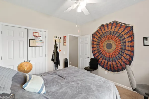 a bedroom with a large bed and a chandelier