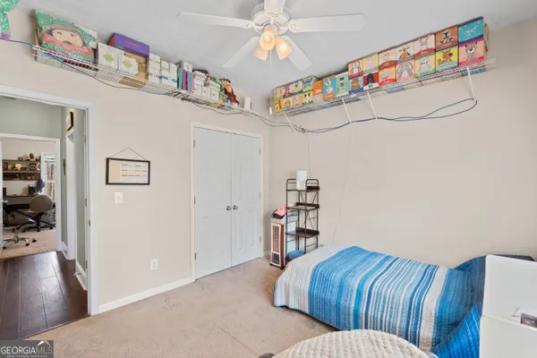 a bedroom with furniture and a book shelf