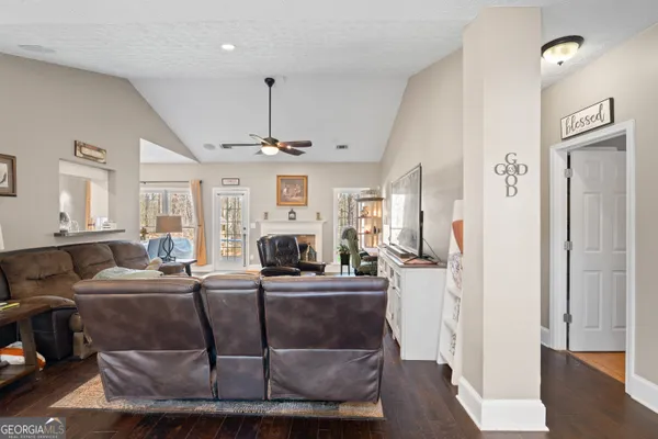 a living room with furniture a wooden floor and a fireplace