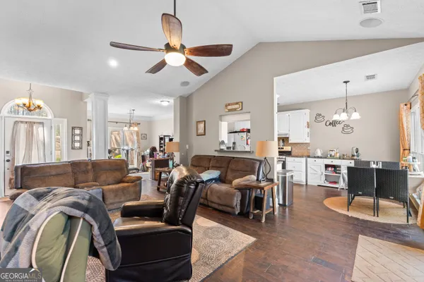 a living room with furniture and wooden floor