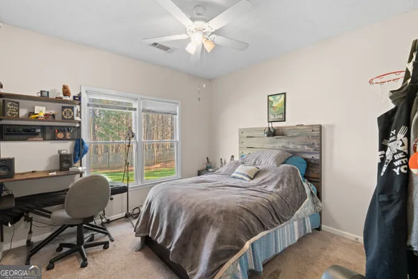 a bedroom with a bed and a desk