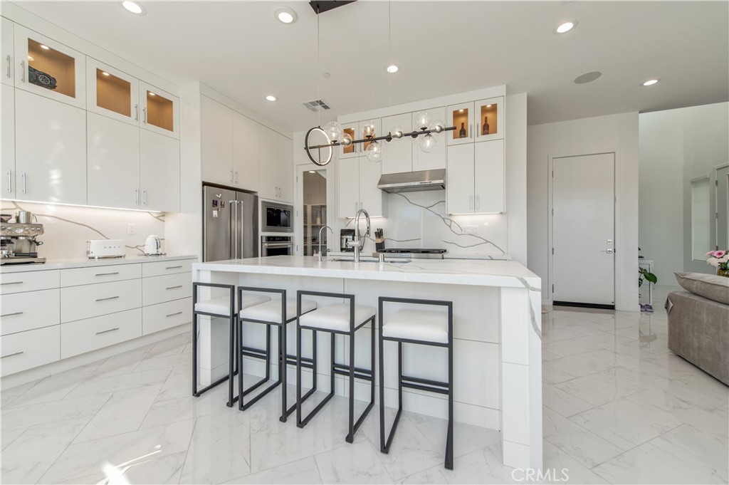 131 Reyes Alley Lake Forest, CA 92630 - Photo 12 of 39 a kitchen with cabinets and chairs