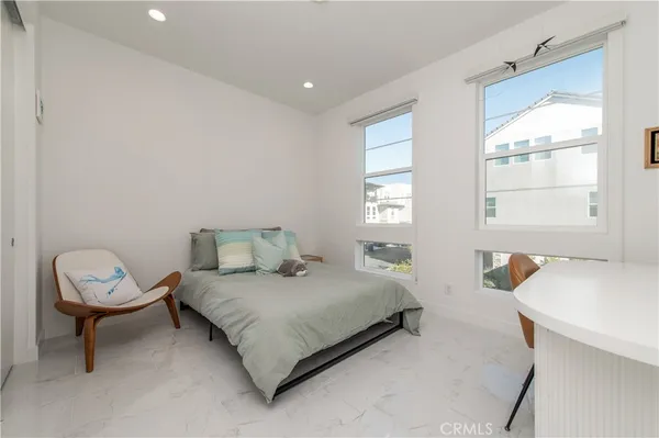 a spacious bedroom with a bed and a window