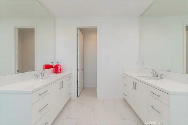 a bathroom with a sink vanity and mirror